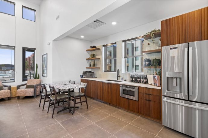 Mesa Vista Affordable Apartments with Modern kitchen and dining area with wooden cabinets, stainless steel appliances, and large windows.