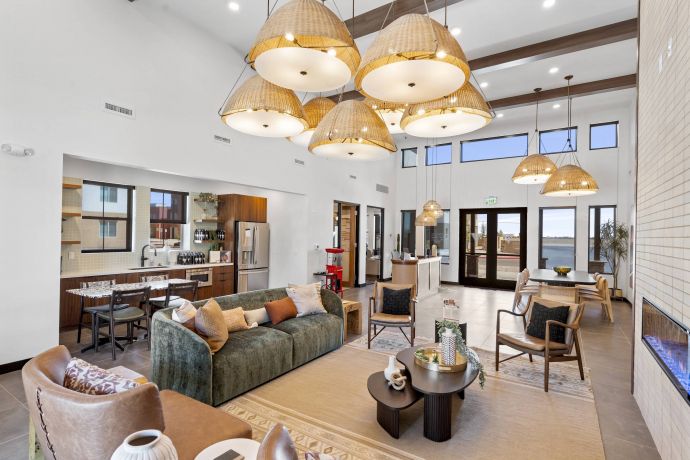 Mesa Vista Affordable Apartments with Spacious modern living room with wicker pendant lights, cozy seating, and large windows letting in natural light.